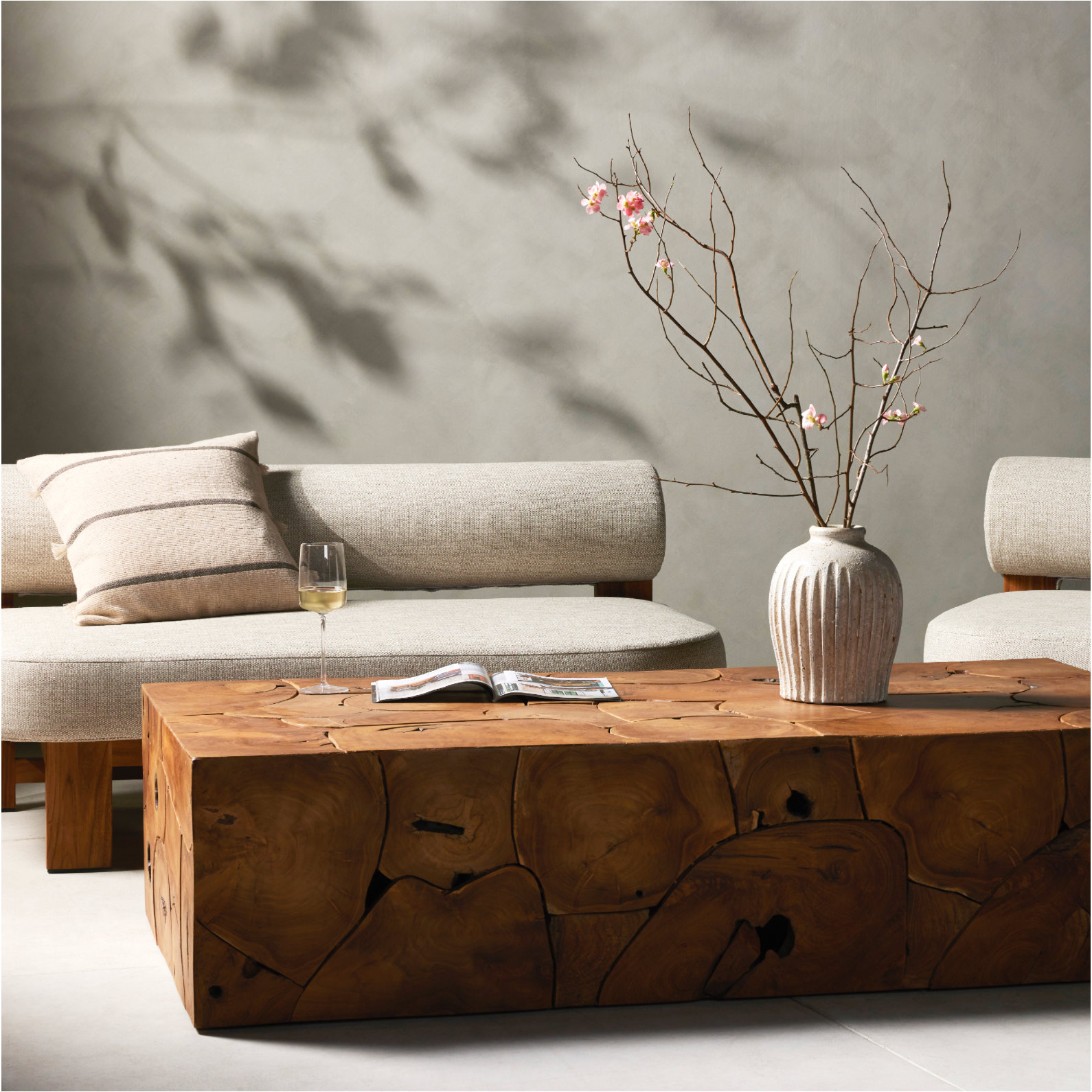 A unique layering piece â€” indoors or out. Made from laminated teak root with miter joinery, a simply shaped coffee table offers organic vibes and plenty of natural movement. Tables will vary from piece to piece, reflective of natural materials. Joint expansion may grow visible over time. Cover or store indoors during inclement weather and when not in use. Amethyst Home provides interior design, new construction, custom furniture and area rugs in the Laguna Beach metro area