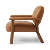 Sleek and inviting, this wood-meets-leather arm chair is timeless in any context. Large cylindrical legs support the upholstered back and seat, which are covered in camel-colored top-grain leather. Spring suspension adds comfort and durability to the seat cushion.Collection: Carnegi Amethyst Home provides interior design, new home construction design consulting, vintage area rugs, and lighting in the Park City metro area.