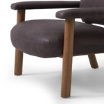 Sleek and inviting, this wood-meets-leather arm chair is timeless in any context. Large cylindrical legs support the upholstered back and seat, which are covered in bark-colored top-grain leather. Spring suspension adds comfort and durability to the seat cushion.Collection: Carnegi Amethyst Home provides interior design, new home construction design consulting, vintage area rugs, and lighting in the Laguna Beach metro area.