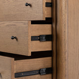 Rounded, chunky dowel legs in an amber oak finish support the overhang top of of this dresser. Six drawers provide ample storage, finished with simple gunmetal hardware Amethyst Home provides interior design, new home construction design consulting, vintage area rugs, and lighting in the Calabasas metro area.